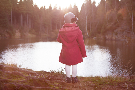 the child at the lake, autumnalの写真素材