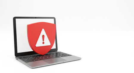 A modern laptop displaying a large red warning shield with an exclamation point on its screen, signifying a security alert or system error.の素材
