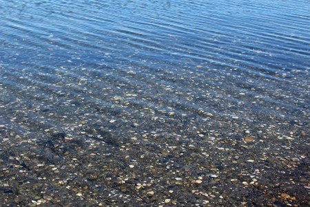 Stones on sea floor under the wave