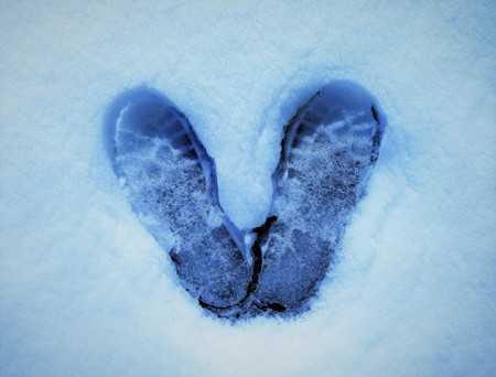 Footprints shaped like wings on the snowの写真素材