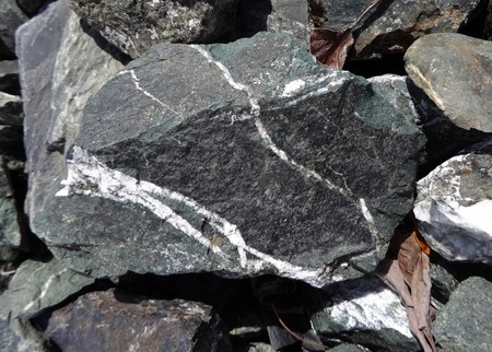 White quartz line formed a greenish rock in to a wishing stoneの写真素材