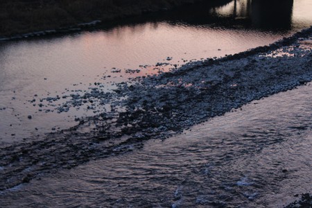 Kuma River flows through at twilight