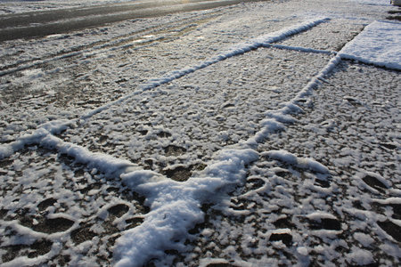 Snow became ice on the sidewalk in the morningの写真素材