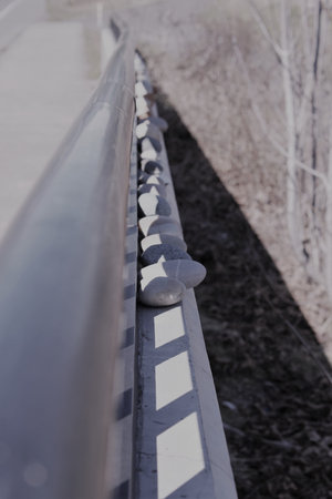 Stones lined up on a rail - gray colorの写真素材