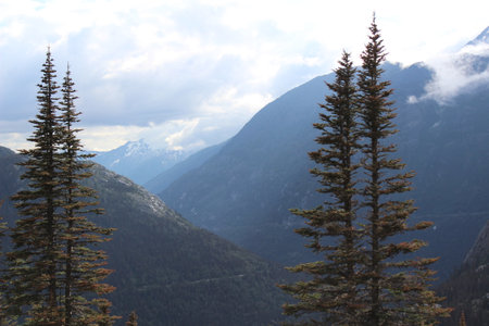 Deep valley and clouds hanging over the top of mountains in Southern Alaskaの写真素材
