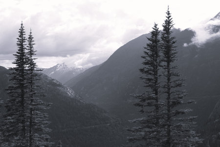 Deep valley and clouds hanging over the top of mountains in Southern Alaskaの写真素材
