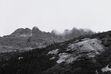 Clouds hanging over the top of rugged mountains in Southern Alaskaの写真素材