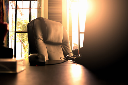 BIg Boss Chair, notebook and stamp on the table with sunray on the backgroundの写真素材