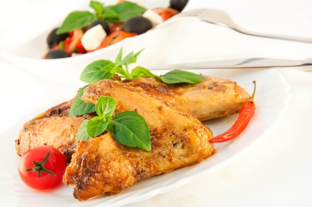 Chicken wings a grill with a tomato and a basil
の写真素材
