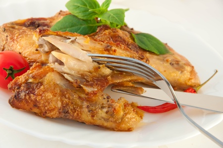 Chicken wings a grill with a tomato and a basil
の写真素材