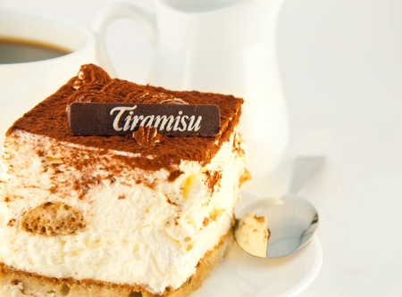 Cake tiramisu and a cup of hot coffeeの写真素材