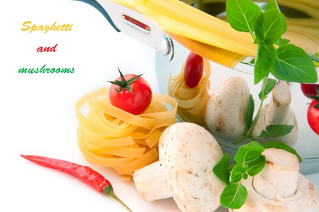Spaghetti, mushrooms and tomatoes in a pan, a basil branchの写真素材