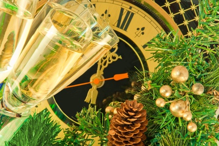 Christmas card. Glasses of champagne on New Year's Eve against an ancient wall clockの写真素材