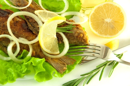 Fish fried, a crucian with a lemon, rosemary and olive oilの写真素材