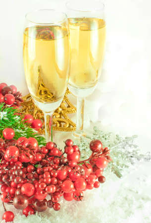 Christmas champagne and branch of berries with a fur-treeの写真素材