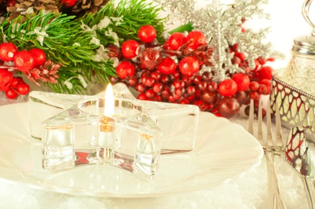 Christmas table layout, candlestick in the form of a star with a branch of berriesの写真素材