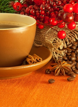 Christmas branch from berries and a fur-tree and a cup of coffeeの写真素材