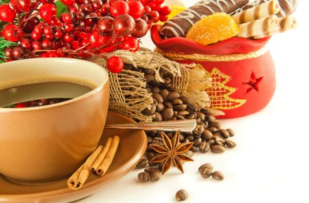 Christmas branch from berries and a fur-tree and a cup of coffeeの写真素材