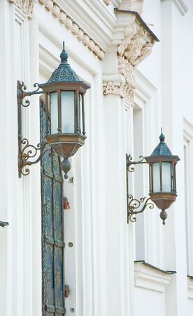 Ancient lanterns on white walls of a monasteryの写真素材