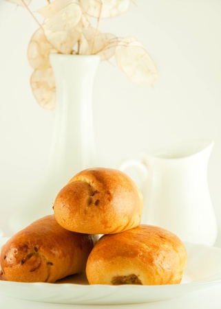 Fresh pies and cup of fragrant coffee on a white backgroundの写真素材