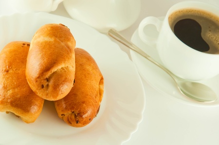 Fresh pies and cup of fragrant coffee on a white backgroundの写真素材