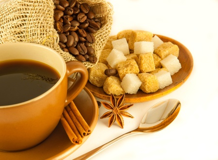 Cup of coffee with chocolates, coffee grains with cinnamon and an aniseの写真素材
