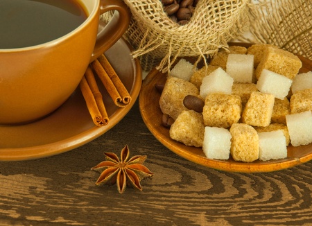 Cup of coffee with chocolates, coffee grains with cinnamon and an aniseの写真素材