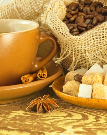 Cup of coffee with chocolates, coffee grains with cinnamon and an aniseの写真素材