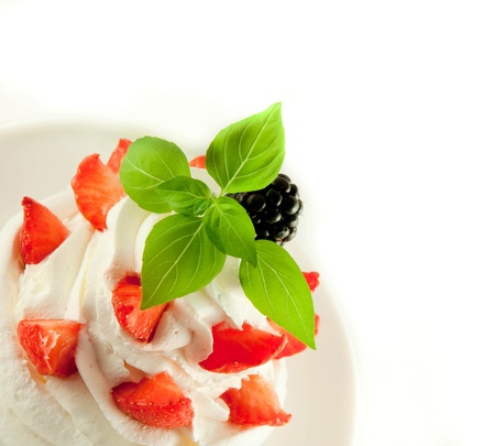 Cake from cream, strawberries and blackberries, a cup of fragrant coffeeの写真素材