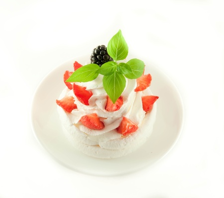 Cake from cream, strawberries and blackberries, a cup of fragrant coffeeの写真素材