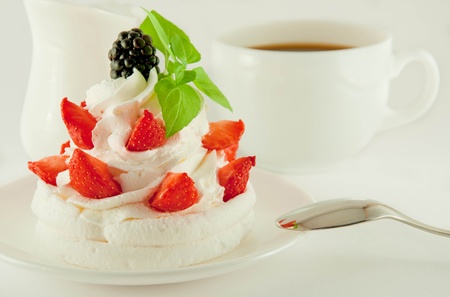 Cake from cream, strawberries and blackberries, a cup of fragrant coffeeの写真素材