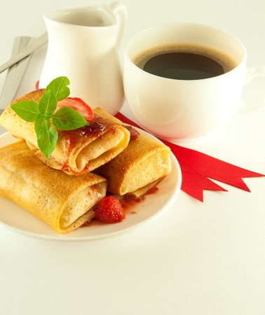 Fritters with red ribbon and mint and a cup of coffeeの写真素材