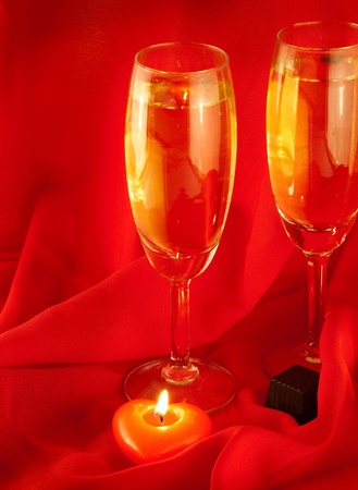 Celebratory table layout with red napkins and candles in the form of heartの写真素材