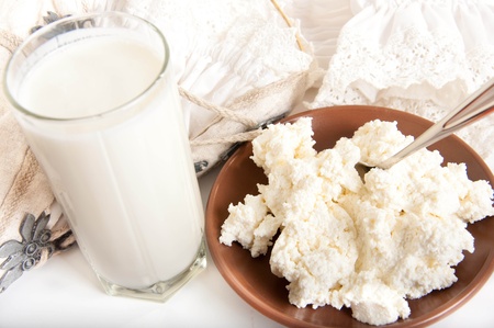 Milk and cottage cheese on the white napkin, a healthy breakfastの写真素材