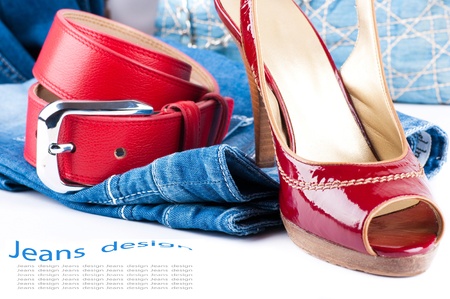 Red belt and shoes, a jeans bag and a skirt on a white backgroundの写真素材