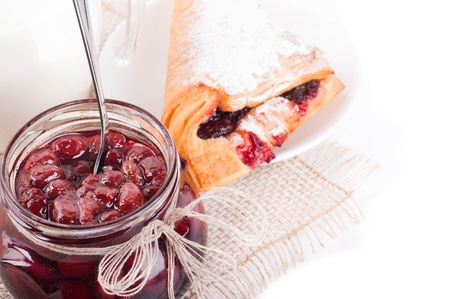 House jam and croissant with a cherry on a rasping napkinの写真素材