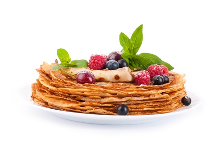 Pancakes with berries and mint on a white backgroundの写真素材