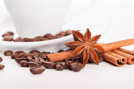 Sticks of cinnamon and an anisic star on coffee grainsの写真素材