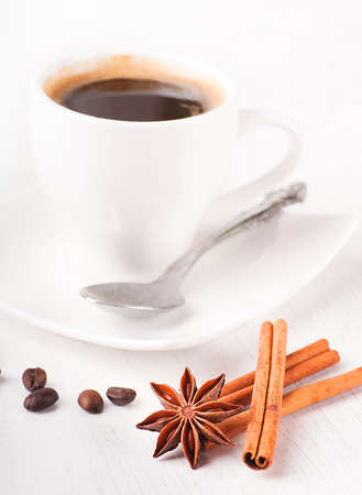 Sticks of cinnamon and an anisic star on coffee grainsの写真素材