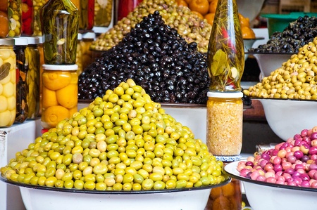 It is a lot of multi-colored olives and olive oil in the marketの写真素材