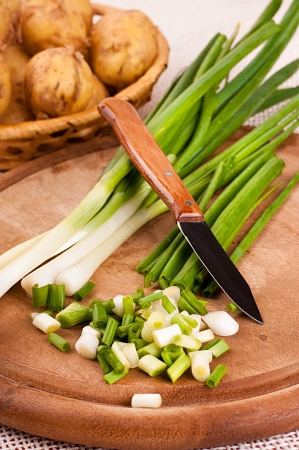 Green onions cut on a wooden boardの写真素材