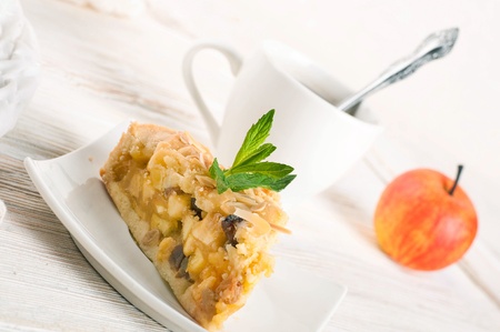 Apple pie and fresh apples on a wooden tableの写真素材