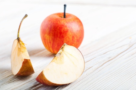 Slices of ripe apples on a wooden table