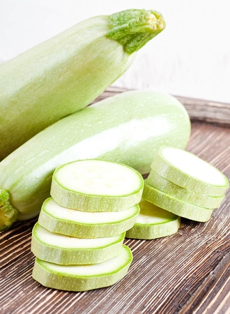 Green zucchini on an old wooden boardの写真素材