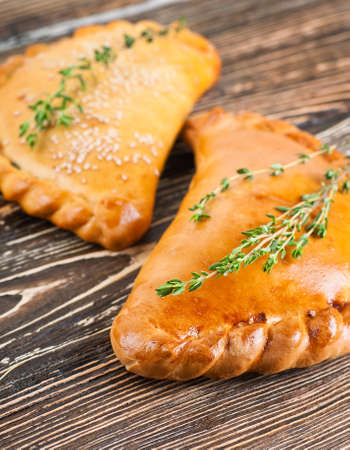 Fresh pies with meat and cheese, bread productsの写真素材