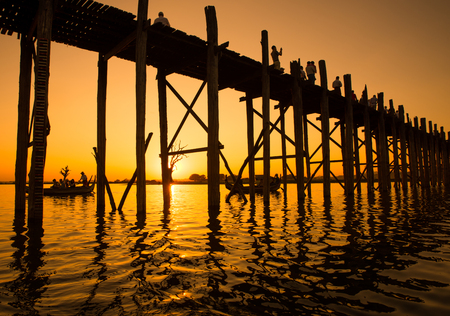 Bridge U-Bein teak bridge is the longest. Sunset with silhouettes of people unrecognizableの写真素材