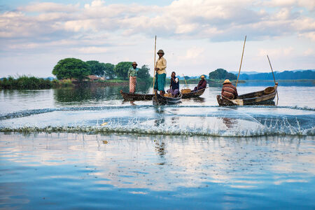 Mandalay - December 3: Fishermen catch fish December 3, 2013 in Mandalay. Fishermen show ancient way of fishing netsのeditorial素材