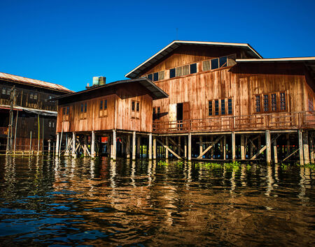 Ancient houses and their reflection in the water on the Inle Lake, Myanmarのeditorial素材