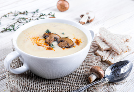 Champignons mushroom soup on a wooden boardの写真素材