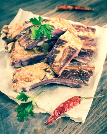 Smoked lamb ribs on wooden table.の写真素材